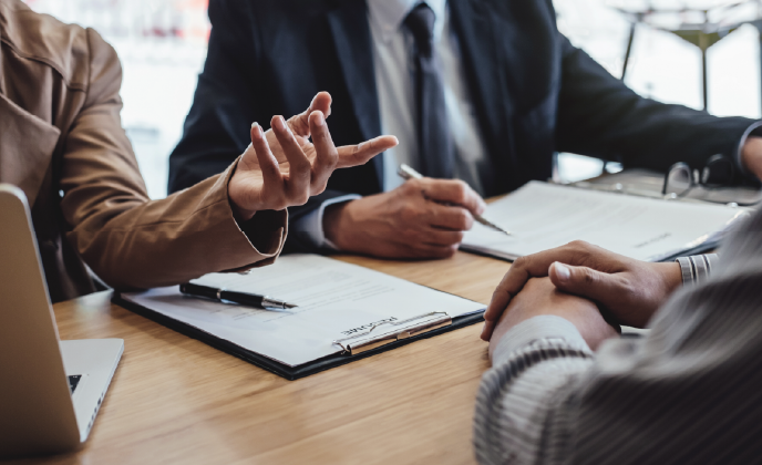 people at a desk having a meeting